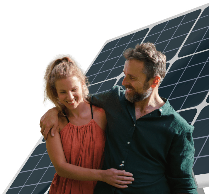 A middle aged couple embracing each other in front of a solar panel